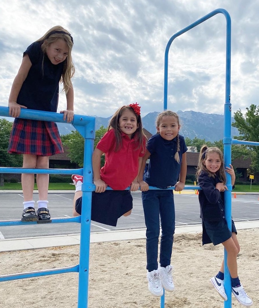 Four girls smiling on the playground